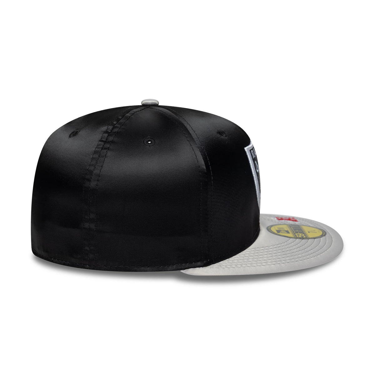 LA Raiders NFL Satin Black & Grey New Era 59FIFTY Fitted Cap, rear view showing the white embroidered MLB Batterman logo at the centre back, with a glossy black satin crown and a grey flat visor featuring a gold 59FIFTY size sticker.