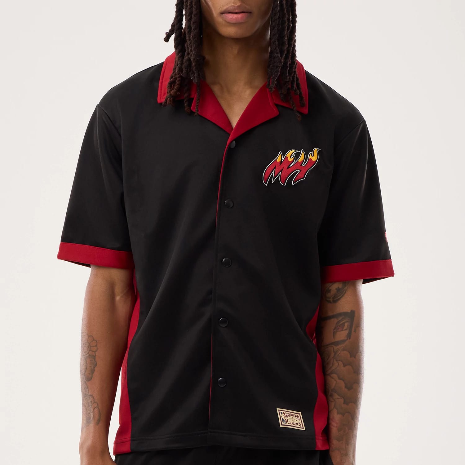 The model is wearing this NBA Hardwood Classic Revere Miami Heat Short Sleeve Shirt in black. 5