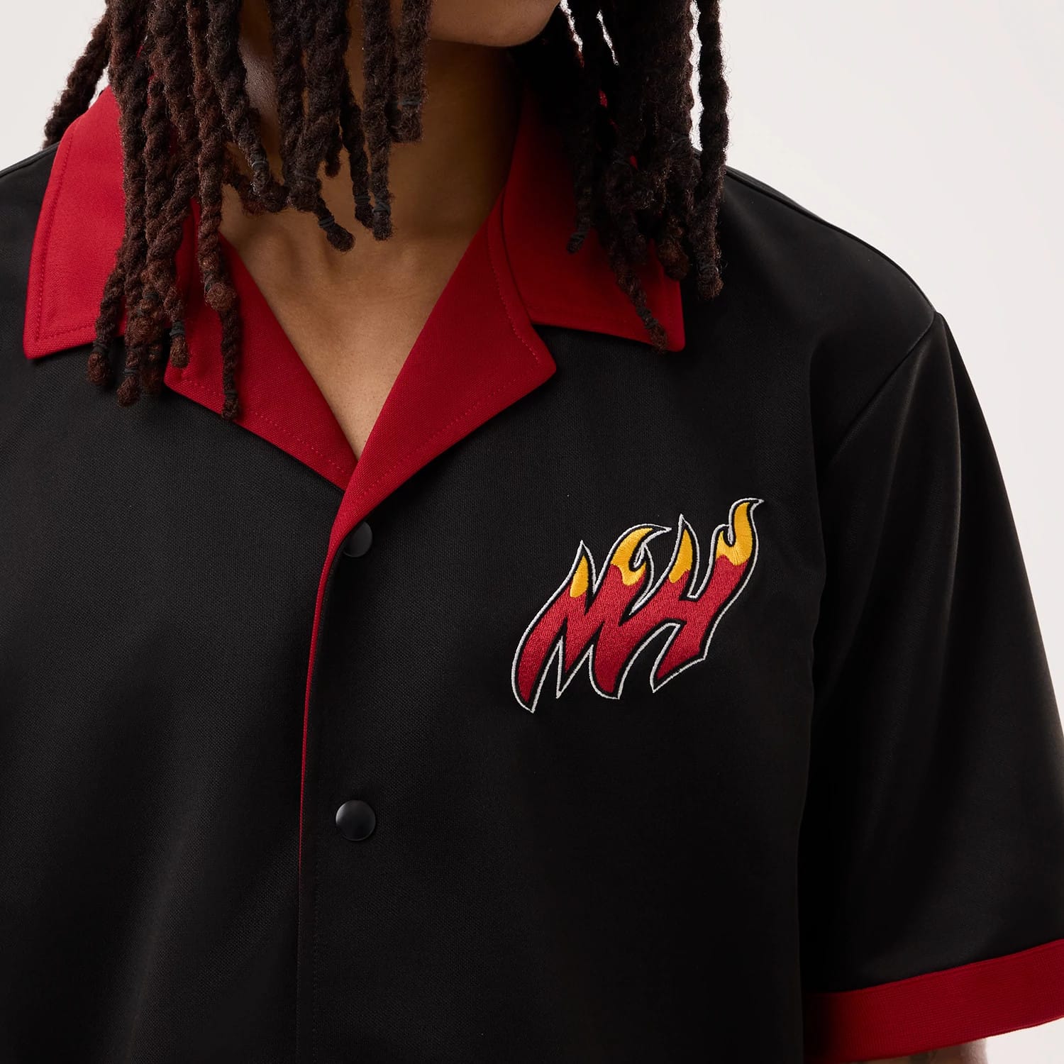 The model is wearing this NBA Hardwood Classic Revere Miami Heat Short Sleeve Shirt in black. 4