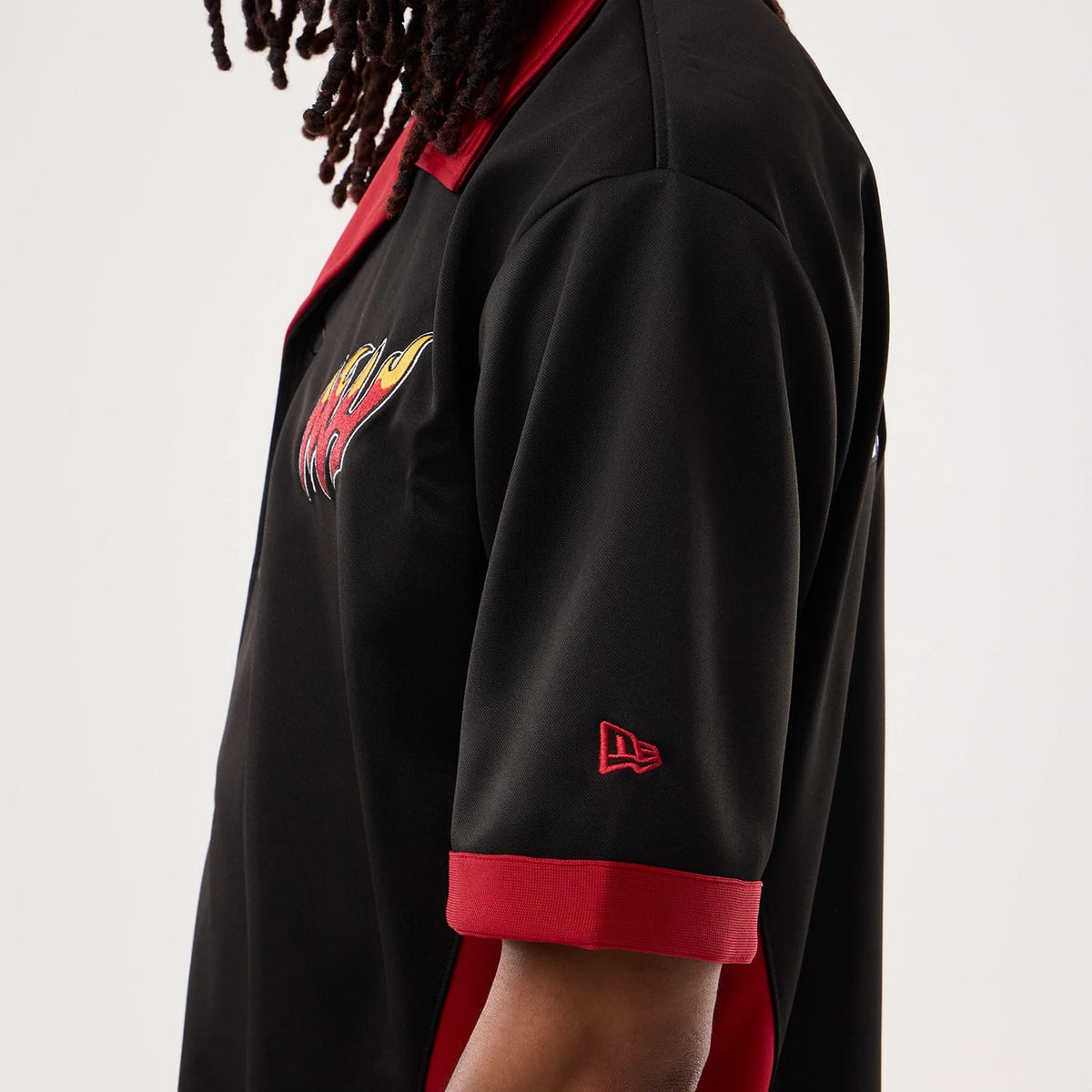 The model is wearing this NBA Hardwood Classic Revere Miami Heat Short Sleeve Shirt in black. 3