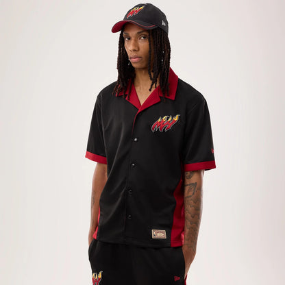 The model is wearing this NBA Hardwood Classic Revere Miami Heat Short Sleeve Shirt in black. 1