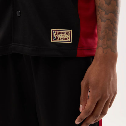 The model is wearing this NBA Hardwood Classic Revere Miami Heat Short Sleeve Shirt in black. 6