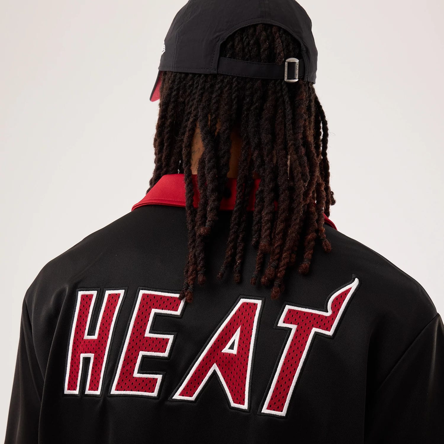 The model is wearing this NBA Hardwood Classic Revere Miami Heat Short Sleeve Shirt in black. 7