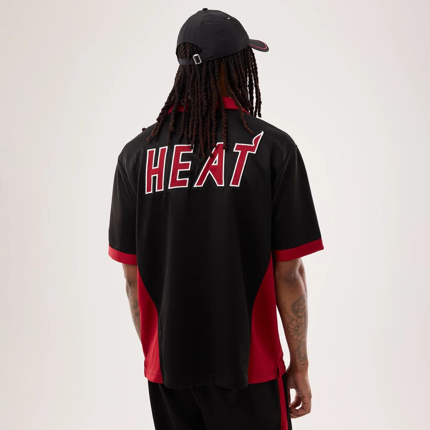 The model is wearing this NBA Hardwood Classic Revere Miami Heat Short Sleeve Shirt in black. 2