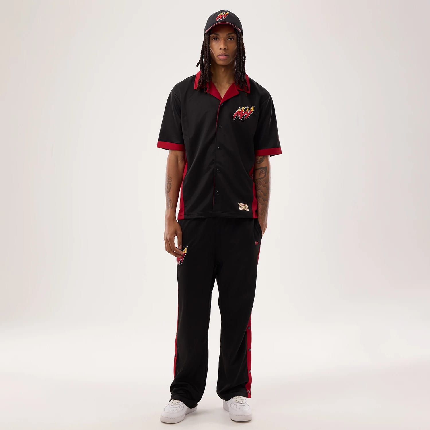 The model is wearing this NBA Hardwood Classic Revere Miami Heat Short Sleeve Shirt in black. 8