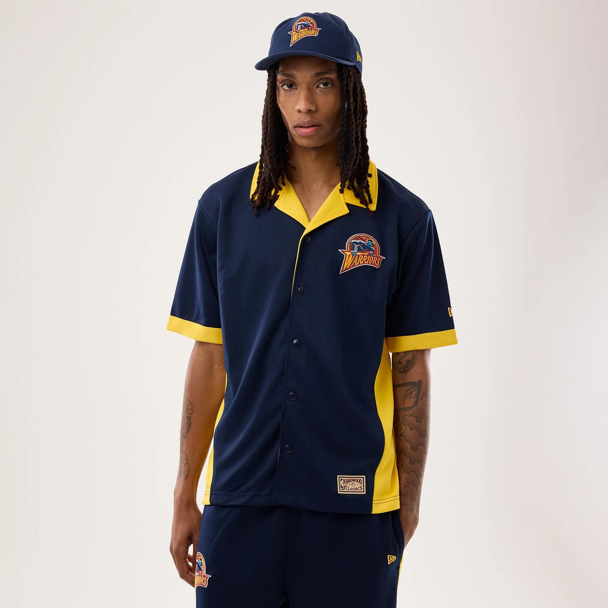 The model is wearing this NBA Hardwood Classic Revere Golden State Warriors Short Sleeve Shirt in dark blue. 1