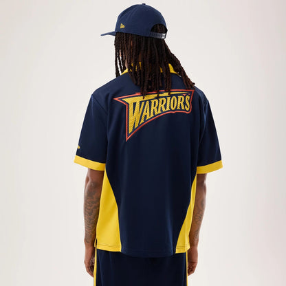The model is wearing this NBA Hardwood Classic Revere Golden State Warriors Short Sleeve Shirt in dark blue. 2