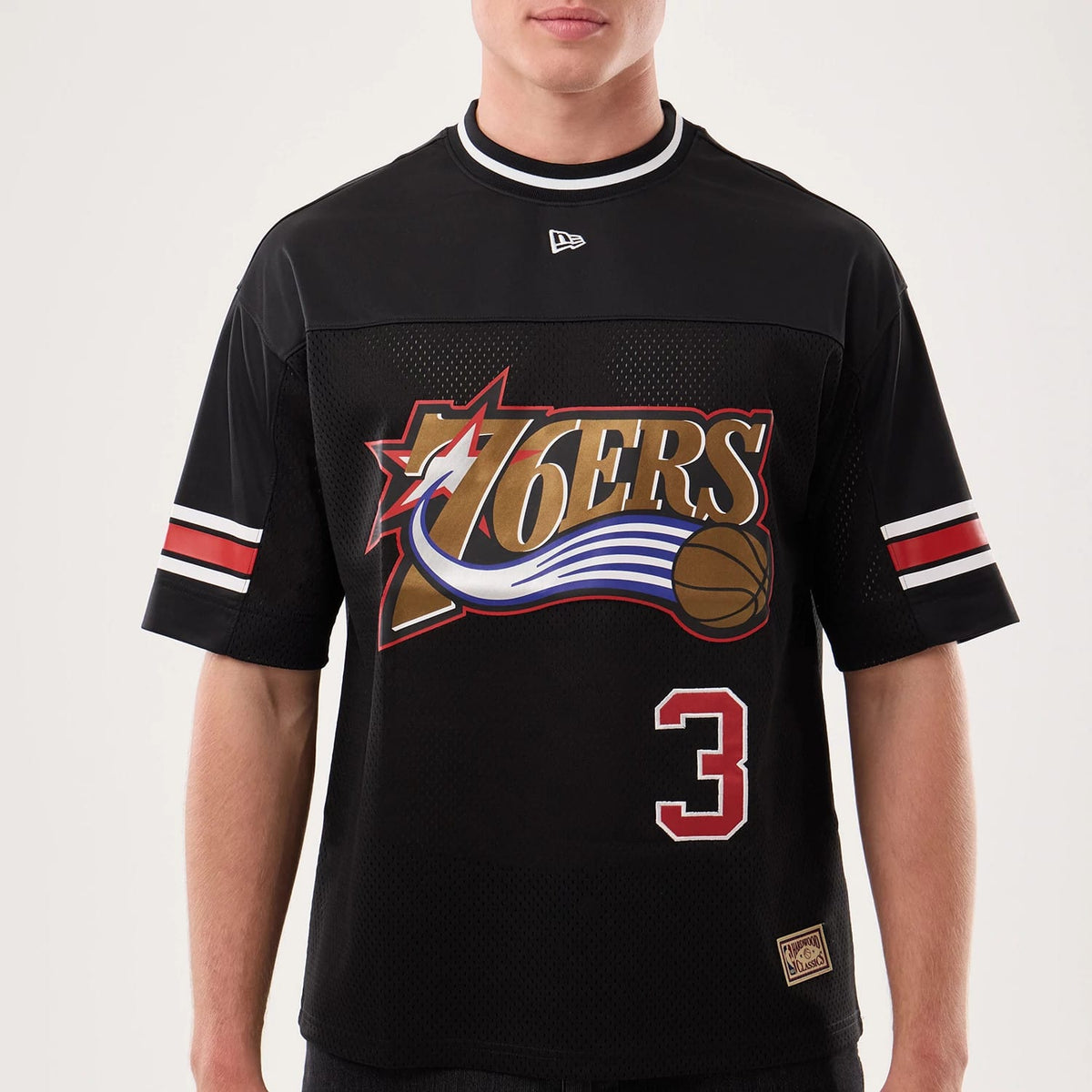 The model is wearing this NBA Hardwood Classic Mesh Oversized Philadelphia 76ers T-Shirt in black. 5