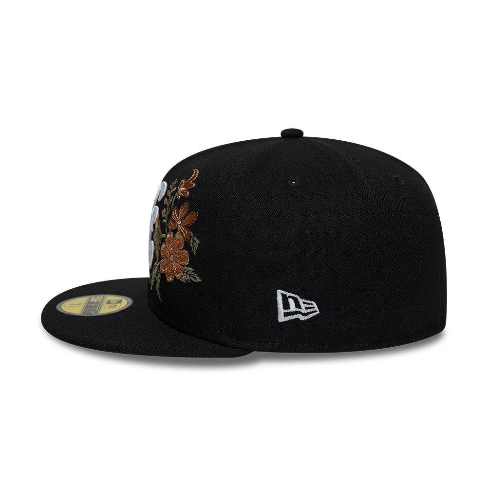 New Era Floral Black 59FIFTY Fitted Cap, side view showing the white embroidered New Era flag logo on the left side, orange and brown floral embroidery on the front panel, and a flat black visor with the gold 59FIFTY size sticker.