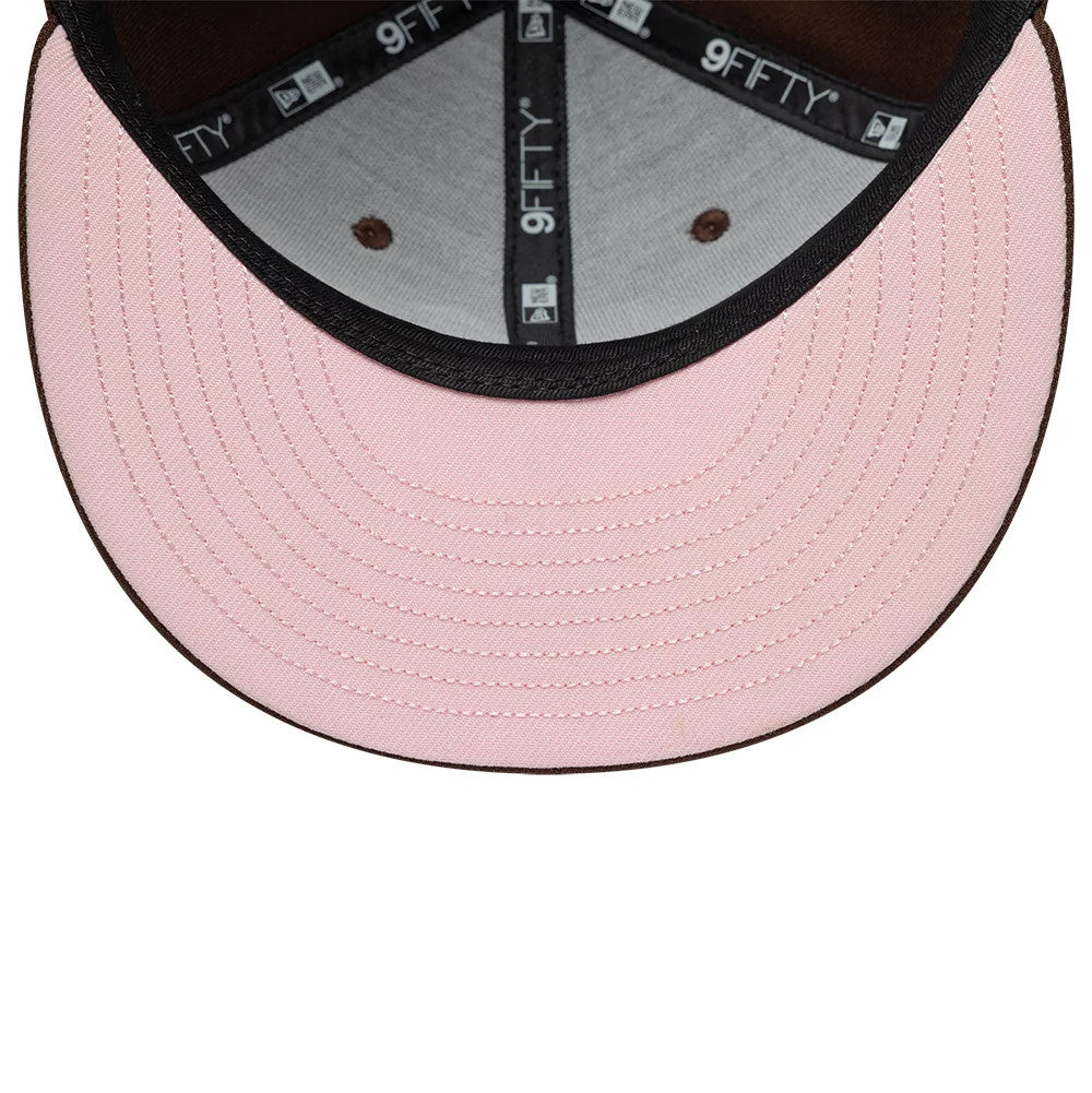 New Era Floral Dark Brown 9FIFTY Snapback Adjustable Cap, inside view showing the light pink undervisor, black 9FIFTY taping along the seams, and brown eyelets on the light interior crown fabric.