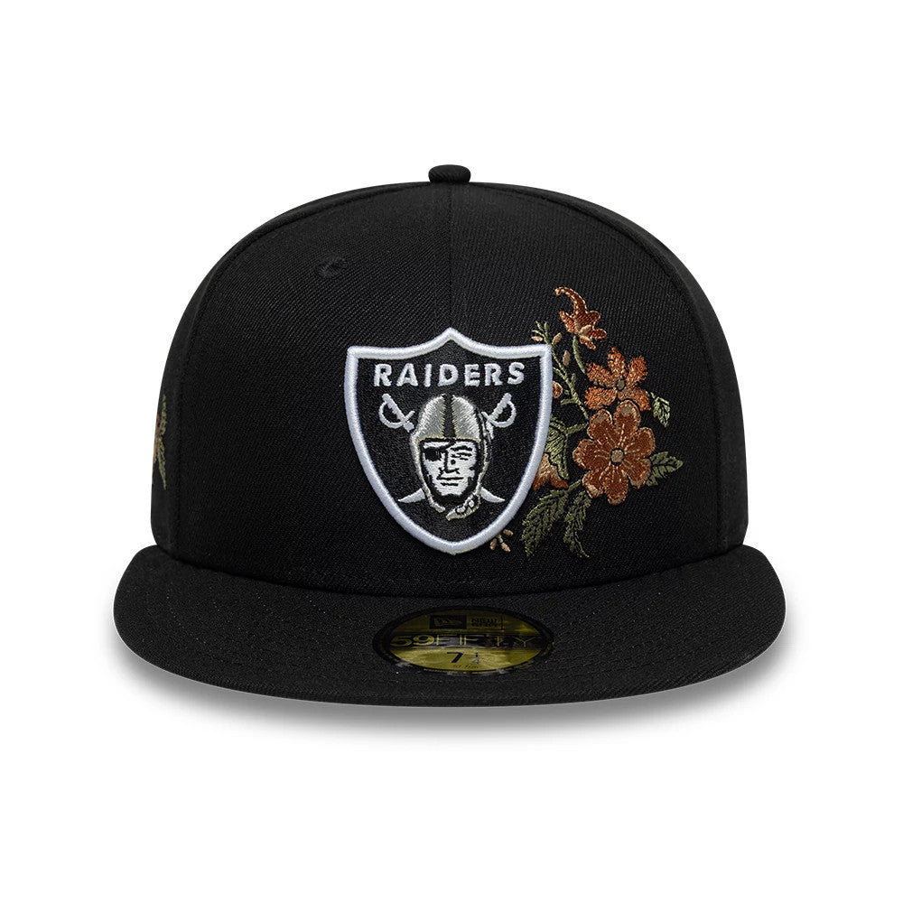 Las Vegas Raiders NFL Floral Black New Era 59FIFTY Fitted Cap, front view showcasing the raised white and black Raiders shield logo embroidered on the structured black crown, with detailed floral embroidery in tones of orange and gold beside it.
