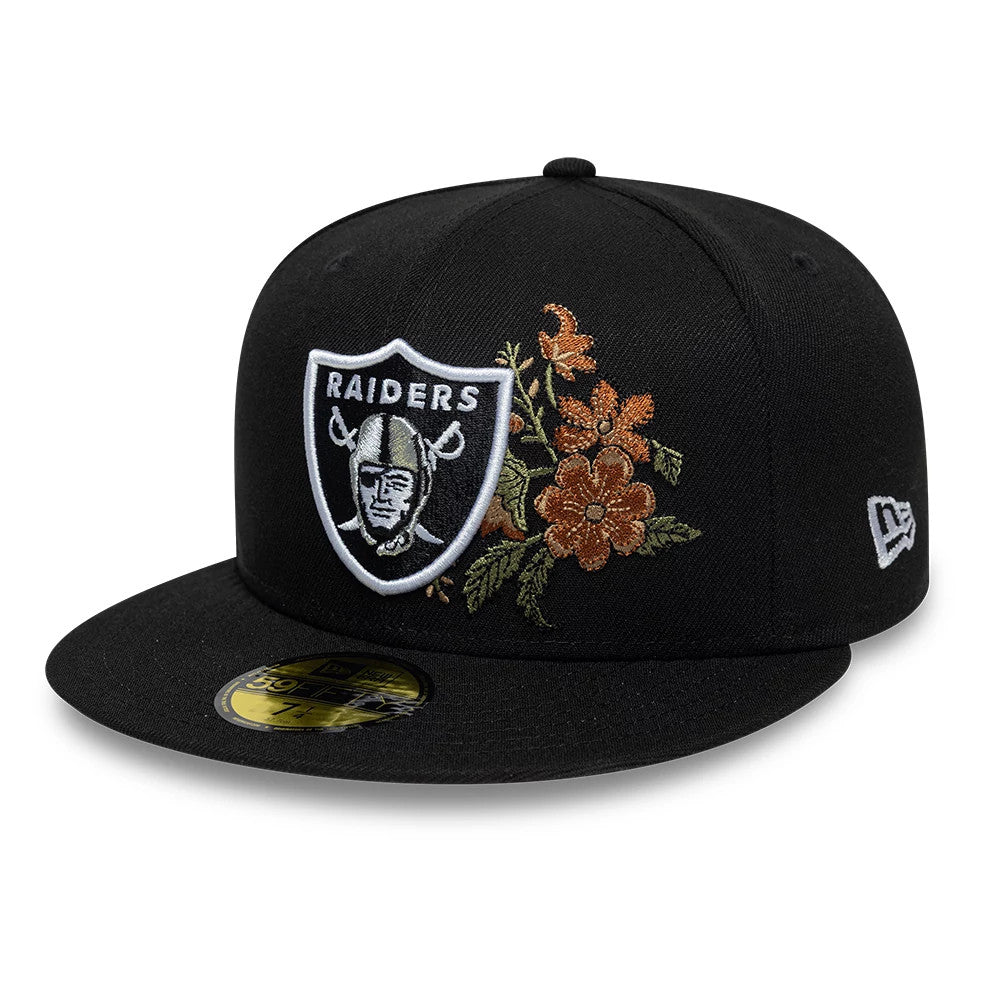 Las Vegas Raiders NFL Floral Black New Era 59FIFTY Fitted Cap, three-quarter view showing a raised white embroidered Raiders logo on the front panel, detailed floral embroidery on the side, and a gold 59FIFTY size sticker on the flat black visor.