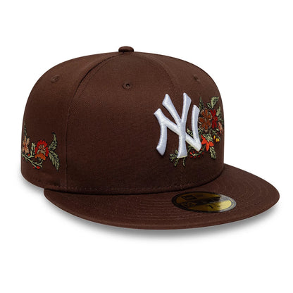 New York Yankees MLB Floral Dark Brown New Era 59FIFTY Fitted Cap, three-quarter view showing the white raised embroidered NY logo on the front panel, floral embroidery on the side, and a gold 59FIFTY size sticker on the flat dark brown visor.