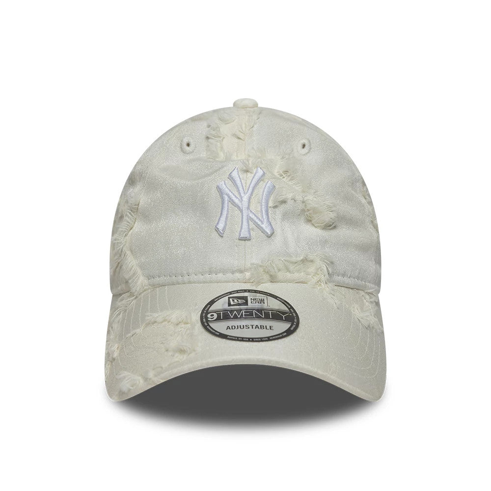 New York Yankees MLB Frayed Cream New Era 9TWENTY Adjustable Cap, front view showing the white raised embroidered NY logo on the crown, frayed distressed throughout the cream fabric, and the 9TWENTY size sticker on the curved visor.