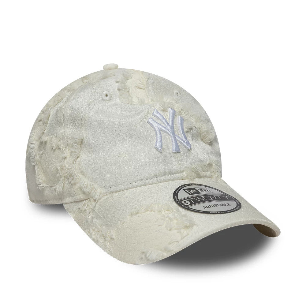 New York Yankees MLB Frayed Cream New Era 9TWENTY Adjustable Cap, front view showing the raised white embroidered NY logo on the distressed cream fabric, with a 9TWENTY size sticker on the slightly curved visor.