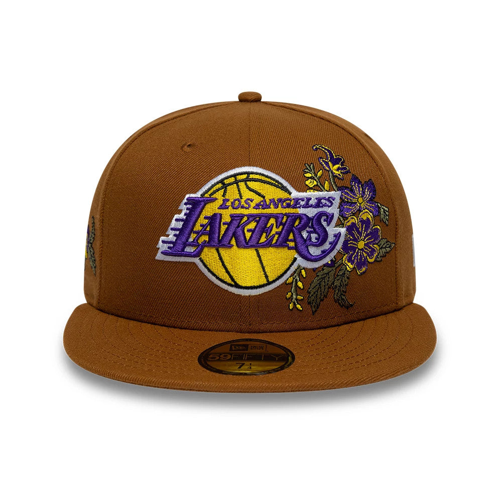 LA Lakers NBA Floral Brown New Era 59FIFTY Fitted Cap, front view showing the purple and yellow LA Lakers logo embroidered on the brown front panel, surrounded by intricate floral designs, with a gold 59FIFTY size sticker on the visor.