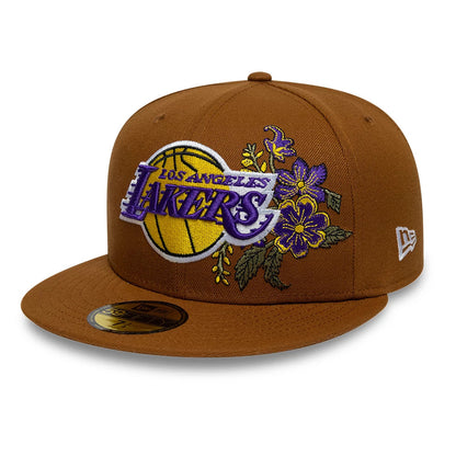 LA Lakers NBA Floral Brown New Era 59FIFTY Fitted Cap, three-quarter view showing the embroidered Lakers logo with a basketball and purple floral design on the front panel, brown flat visor, and the New Era flag logo on the left side.