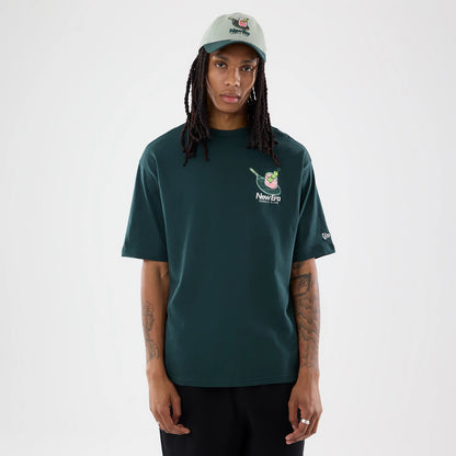 The model is wearing this New Era Tennis Graphic Oversized T-Shirt in dark green. 1