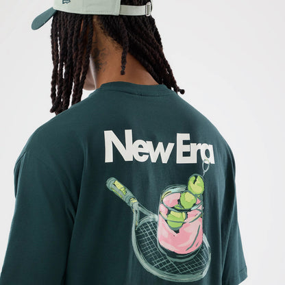 The model is wearing this New Era Tennis Graphic Oversized T-Shirt in dark green. 4