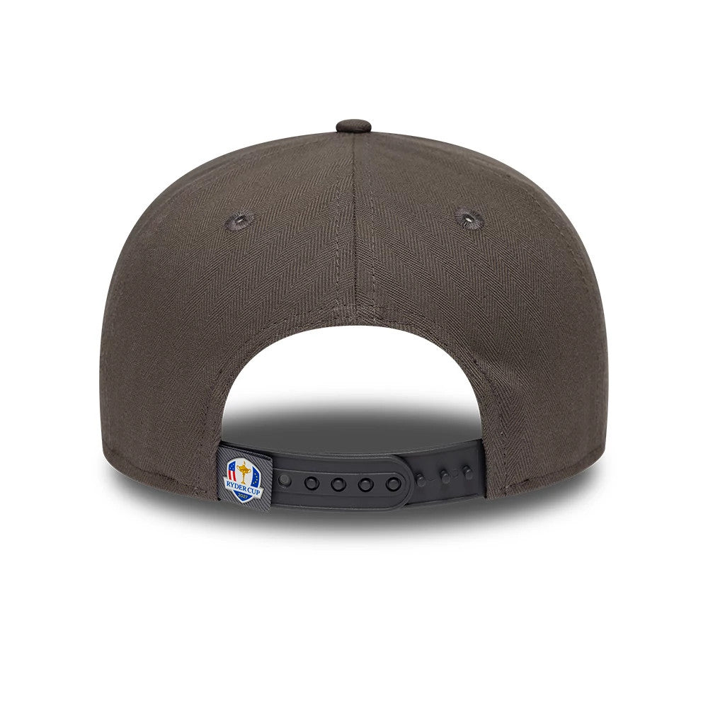 Ryder Cup 2027 Herringbone Grey New Era Retro Crown 9FIFTY Adjustable Cap, rear view featuring the Ryder Cup logo on the centre of the black adjustable strap, with grey herringbone patterned fabric and a top button detail.