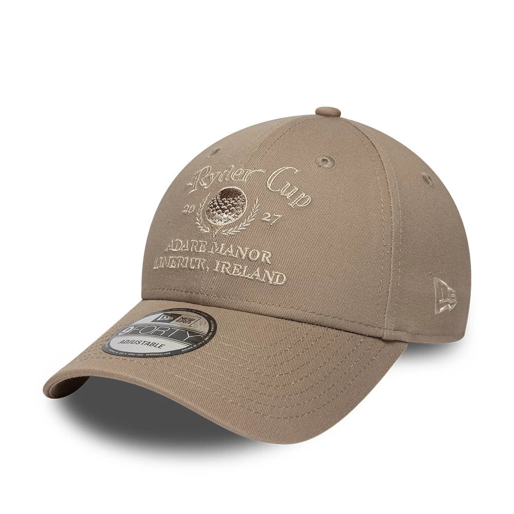 Ryder Cup 2027 Light Brown New Era 9FORTY Adjustable Cap, front view showing white embroidered Ryder Cup lettering and logo with Adare Manor, Limerick, Ireland text below, curved visor with 9FORTY size sticker, and New Era flag logo on the left side.