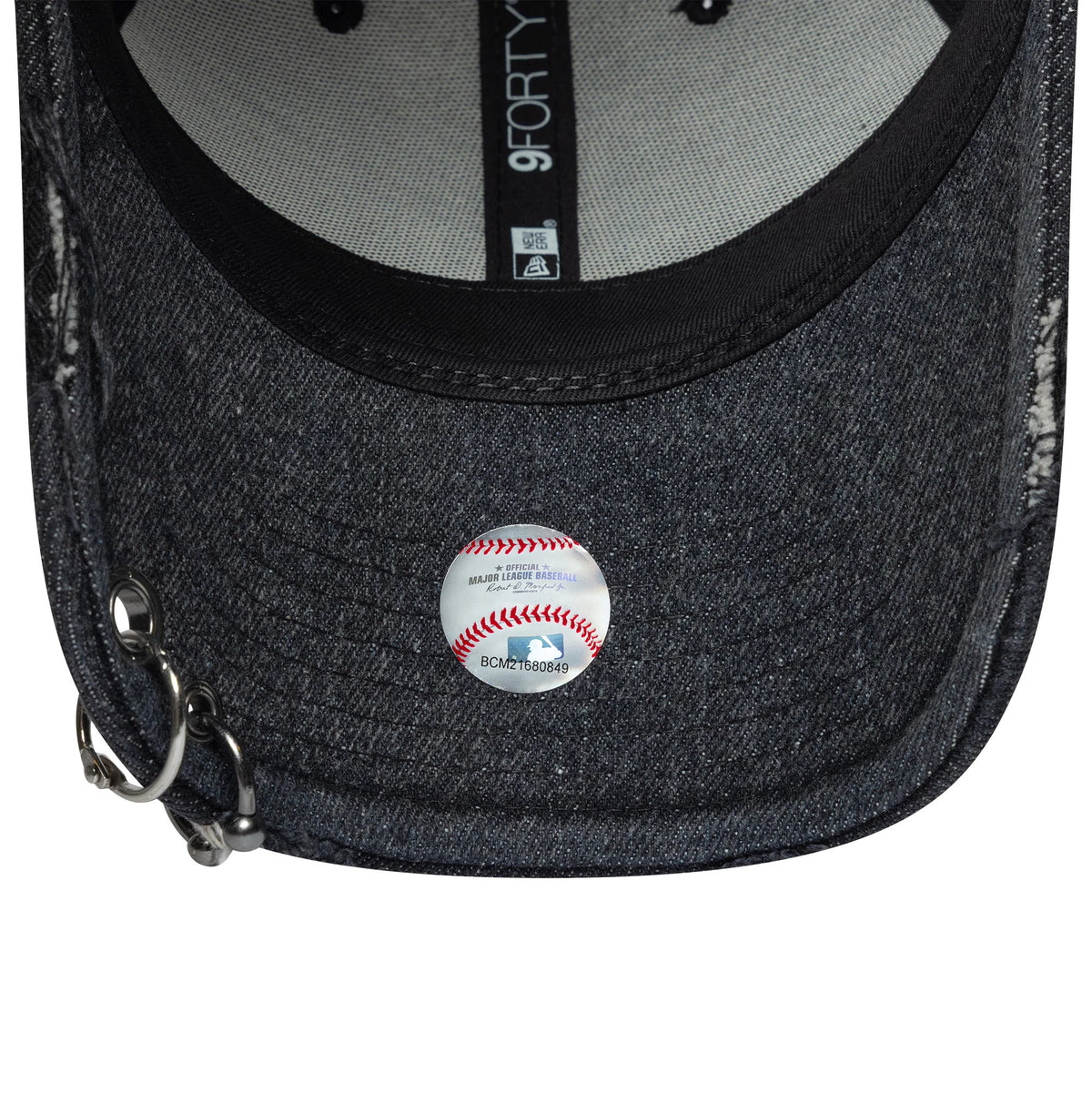 LA Dodgers MLB Hardware Black New Era 9FORTY Adjustable Denim Cap, inside view showing grey taping with a 9FORTY label, a black sweatband, part of the denim undervisor, and rings at the edge, baseball button pin fastened to the front panel.