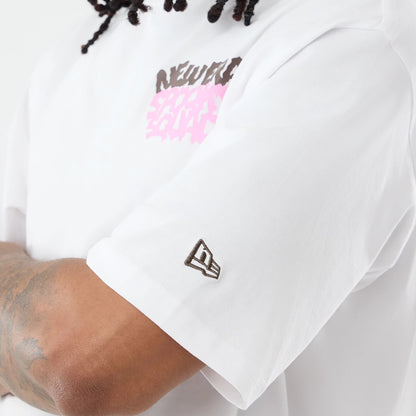 The model is wearing this New Era Spooky Graphic Oversized T-Shirt in white. 5