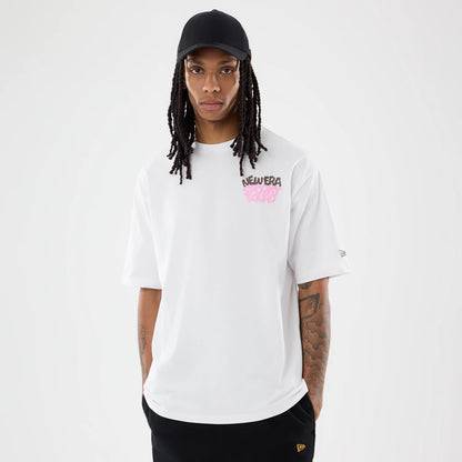 The model is wearing this New Era Spooky Graphic Oversized T-Shirt in white. 1