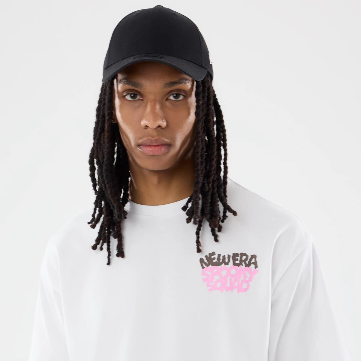 The model is wearing this New Era Spooky Graphic Oversized T-Shirt in white. 6