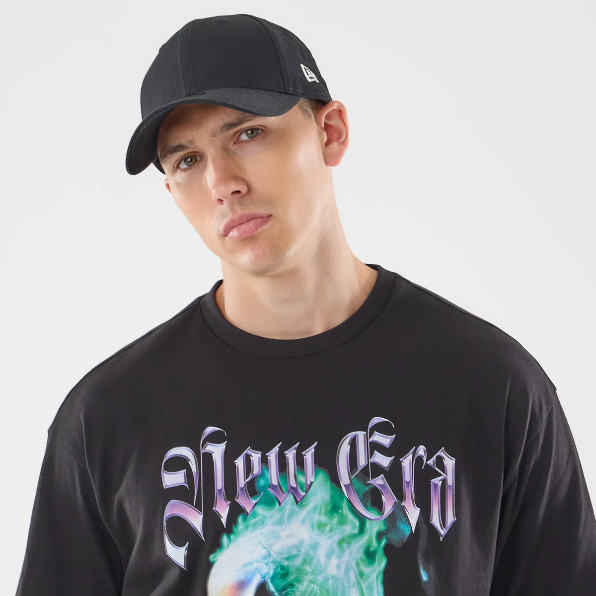 The model is wearing this New Era Skull Graphic Oversized T-Shirt in black. 5