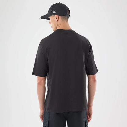 The model is wearing this New Era Skull Graphic Oversized T-Shirt in black. 2