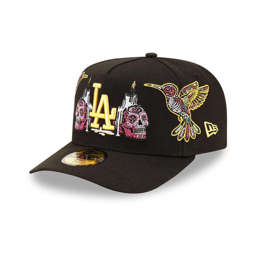 LA Dodgers MLB Day Of The Dead Black New Era 59FIFTY A-Frame Fitted Cap, front view showing yellow embroidered LA logo with colourful sugar skulls and a hummingbird on the black front panels, and gold 59FIFTY size sticker on the visor.