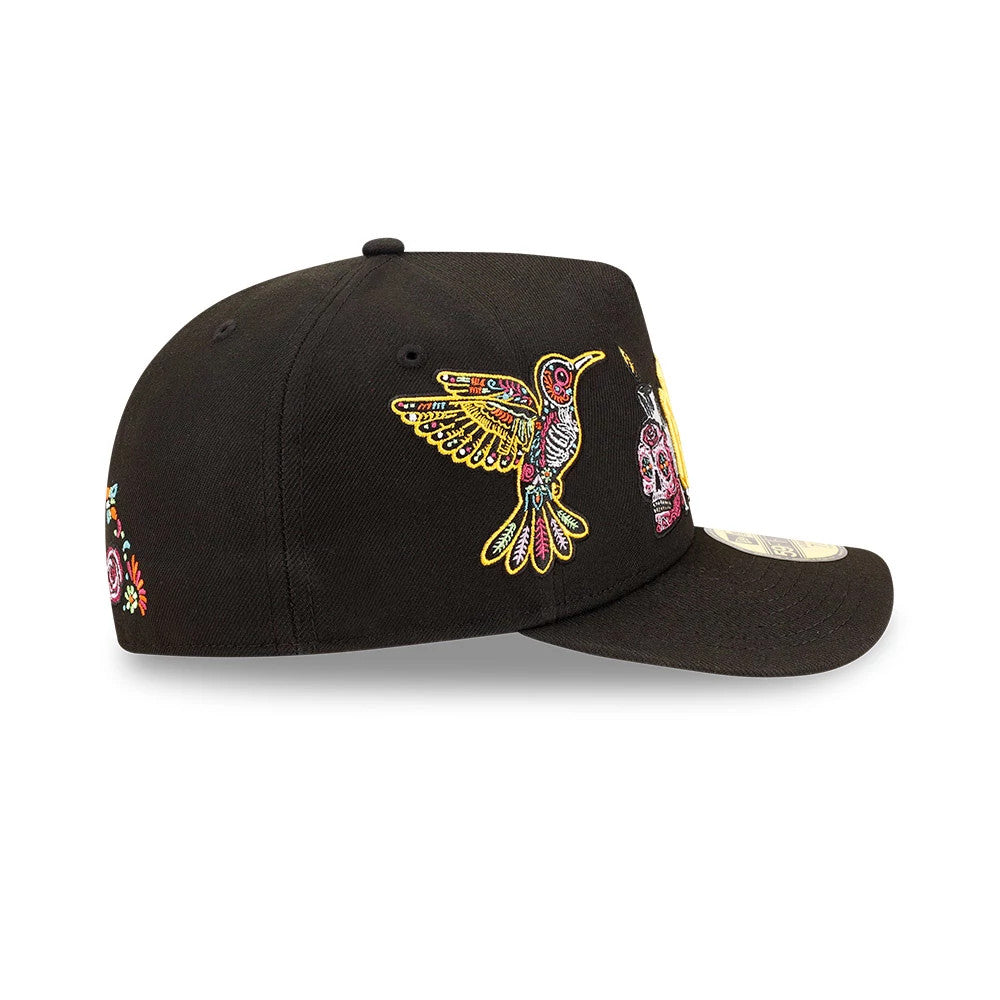 Yankees MLB Day Of The Dead Black New Era 59FIFTY A-Frame Fitted Cap, side view showing a multicoloured embroidered hummingbird on the structured black crown, colourful skull design towards the front panel.