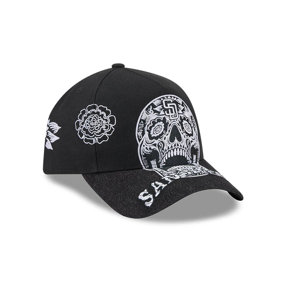 San Diego Padres MLB Day Of The Dead Black New Era 9FORTY A-Frame Adjustable Cap, three-quarter view showing the white sugar skull design with intricate details on the front panel, a black curved visor with SD embroidery.