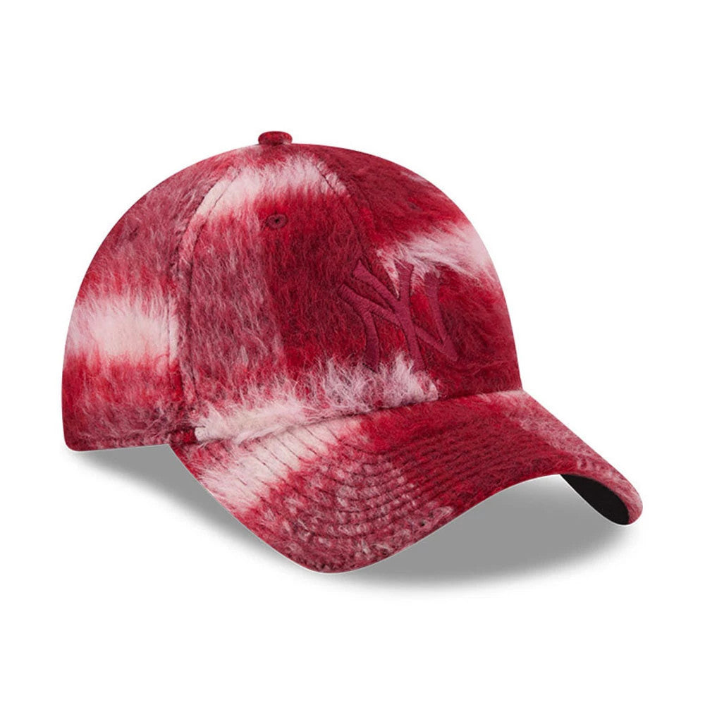 New Era New York Yankees MLB Fabric Story Red Casual Classic Adjustable Cap, three-quarter view showing a red and white textured design, raised embroidered NY logo on the front panel, and a curved red visor with a black undervisor.
