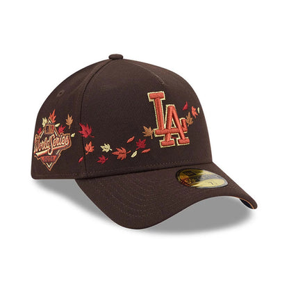 LA Dodgers MLB Fall Story Dark Brown New Era 59FORTY A-Frame Fitted Cap, three-quarter view showing the raised LA logo in autumnal tones on the front, surrounded by embroidered fall leaves, with a 59FORTY size sticker on the curved visor.