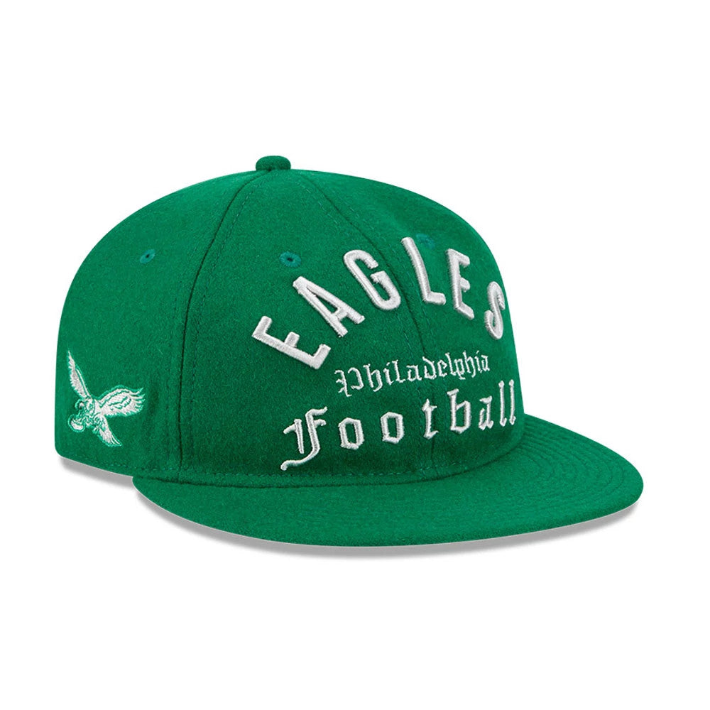 Eagles NFL Historic Arch Green Retro Crown New Era 59FIFTY Fitted Cap, three-quarter view showing white raised embroidered EAGLES PHILADELPHIA FOOTBALL lettering on the front, a flat green visor, and an eagle logo on the left side.