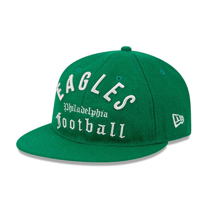 Eagles NFL Historic Arch Green Retro Crown New Era 59FIFTY Fitted Cap, three-quarter view showing raised white Eagles lettering and Philadelphia Football script on the front panels, with a green flat visor and the New Era flag logo on the left side.