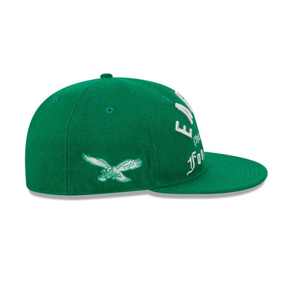 Eagles NFL Historic Arch Green Retro Crown New Era 59FIFTY Fitted Cap, side view showing the white embroidered eagle logo on the left and arched 'EAGLES' lettering on the front panel, paired with a matching green flat visor.