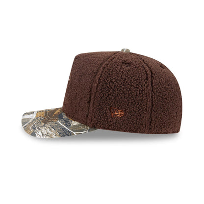 Boston Celtics NBA Hardwood Classic Brown New Era 59FIFTY A-Frame Fitted Cap, side view showing the brown textured crown with an orange embroidered New Era flag logo on the left side, and a multicoloured camo pattern on the flat visor.