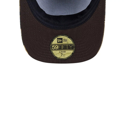 New York Knicks NBA Hardwood Classic Brown New Era 59FIFTY A-Frame Fitted Cap, inside view showing the contrasting black sweatband, the soft grey undervisor, and the prominent gold 59FIFTY size sticker on the brown visor.