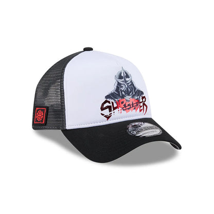 TMNT Splinter White & Black New Era 9FORTY A-Frame Trucker Adjustable Cap, front view showing a Shredder graphic with red lettering on the white structured front panel, black curved visor with 9FORTY size sticker, and mesh side panels with red patch.