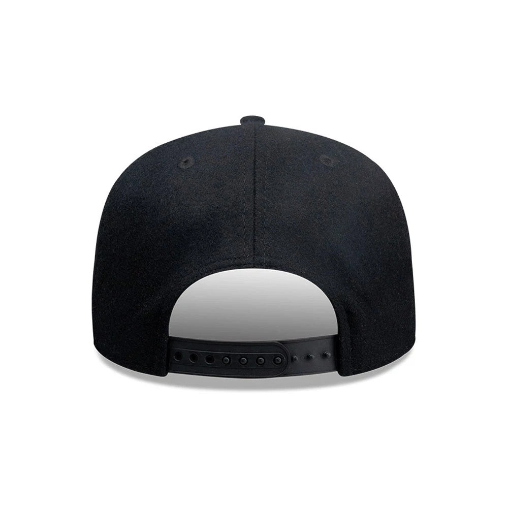 New Era X Omerta Balvin Black New Era 19TWENTY Adjustable Cap, rear view showing the plain black fabric across the structured crown, two black embroidered eyelets on each side, and a black adjustable snapback closure for a customised fit.