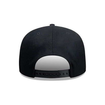 New Era X Omerta Balvin Black New Era 19TWENTY Adjustable Cap, rear view showing the plain black fabric across the structured crown, two black embroidered eyelets on each side, and a black adjustable snapback closure for a customised fit.