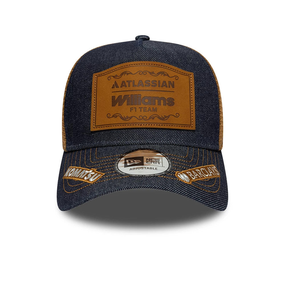 Williams Carlos Sainz Austin Race Special Navy New Era 9FORTY E-Frame Trucker Adjustable Cap, front view showing a brown leather patch with Williams F1 Team logo on the structured navy crown, Komatsu and Barclays logos on the curved visor.