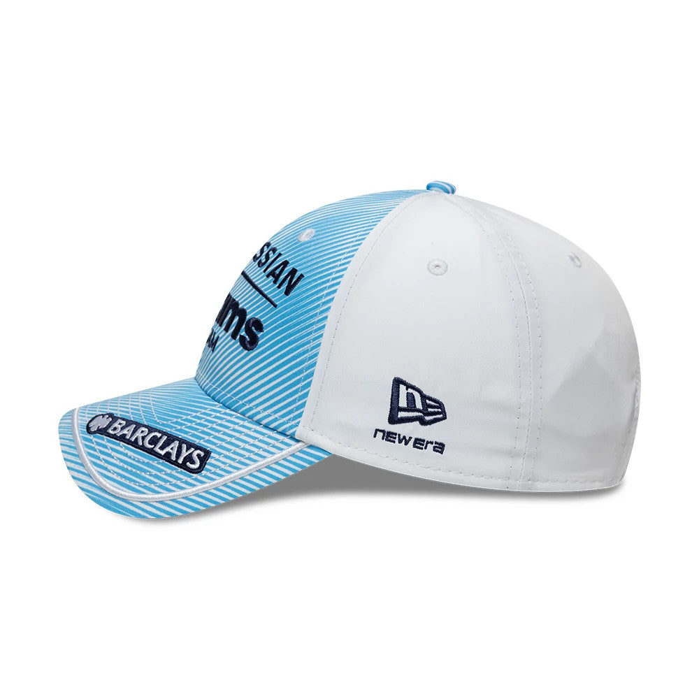 Williams Spain Race Special Blue New Era 9FORTY Adjustable Cap, side view showing the navy embroidered New Era flag logo on the white side panel, a structured blue front with white stripes and branding, and a curved blue visor.