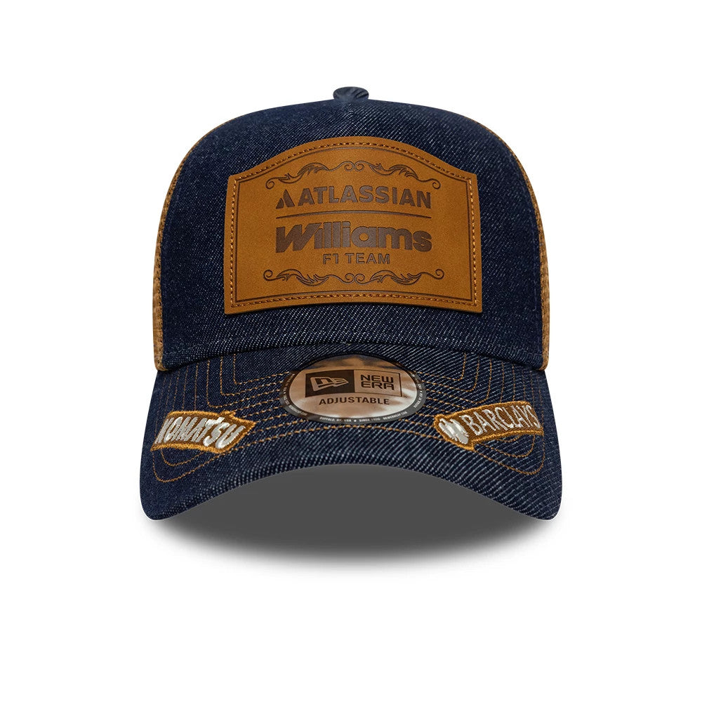 Williams Alex Albon Austin Race Special Navy New Era 9FORTY E-Frame Trucker Adjustable Cap, front view showing a brown leather patch with Williams F1 Team branding, a curved denim visor with embroidered details, and a 9FORTY size sticker on top.