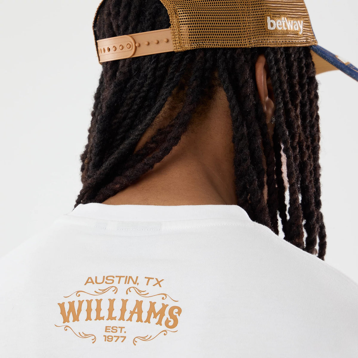 The model is wearing this Williams Austin Race Special Graphic Oversized T-Shirt in white. 5