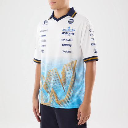 New Era Williams Spain Race Special White T-Shirt, front three-quarter view on a model showing a large blue and gold graphic on the lower front, multiple sponsor logos embroidered across the chest, and navy and gold-striped cuffs.