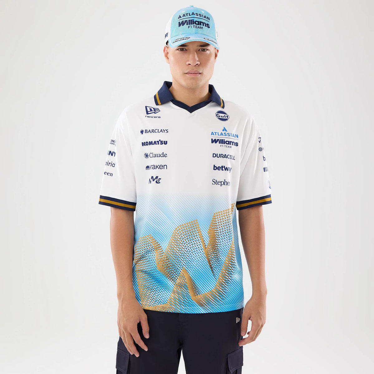 New Era Williams Spain Race Special White T-Shirt, front view on a model showcasing the multi-sponsor graphics across the chest, prominent Atlassian Williams Racing logo on the left side, and a distinctive blue.